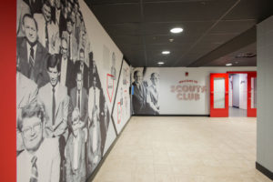 Corner of a hallway with a large display of historic figures painted on wall