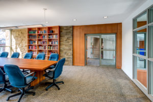 Conference room with wood paneling and bookshelf