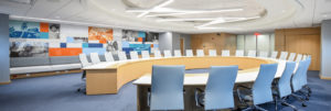 Conference room with large, curved, U-shaped table in the center