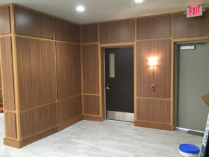 Corner of a lobby with custom wood paneling on the walls