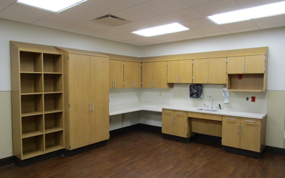 Custom cabinets, shelving, and sink area in hospital